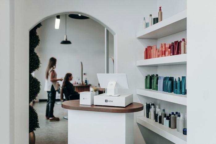 The interior of a small salon with products on the shelves