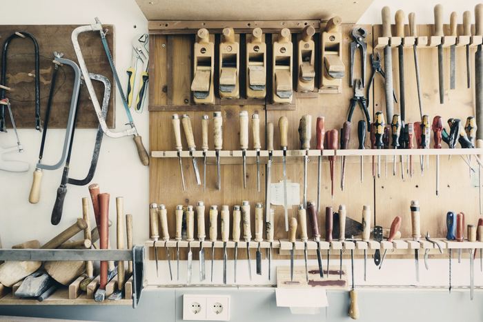 Hand tools hung in order on a workshop rack