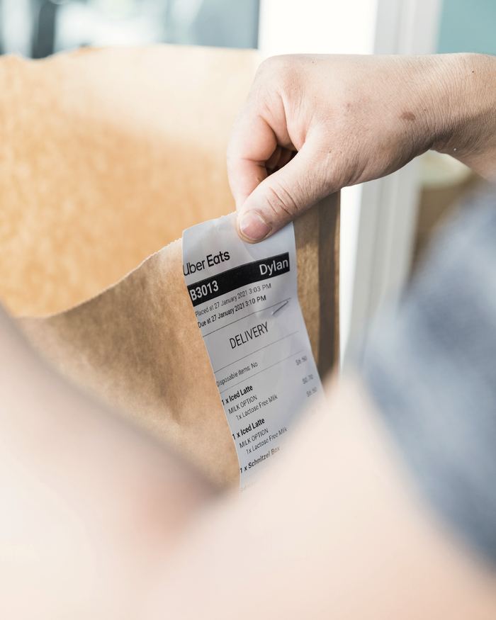 Person holding white and black tag
