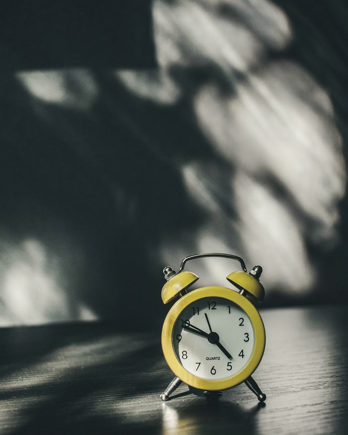 White and gold analog alarm clock