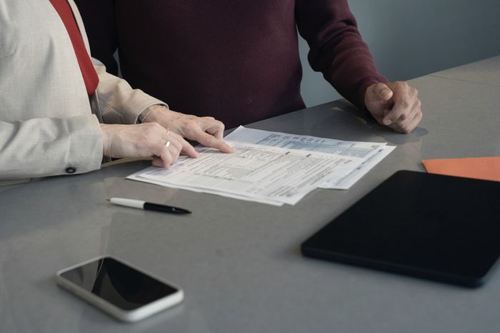 Two people reviewing documents at a table
