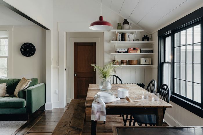 A living room and dining room with a couch and a table