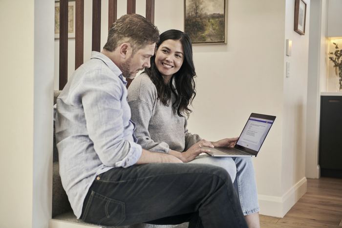 Man sitting beside woman looking at a contract on DocuSign